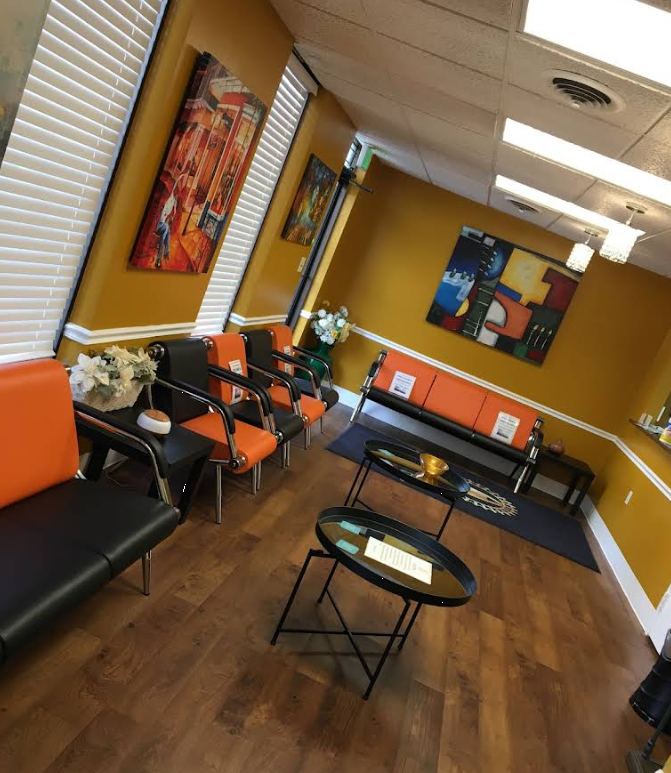 Waiting area with seating, artwork, and coffee tables