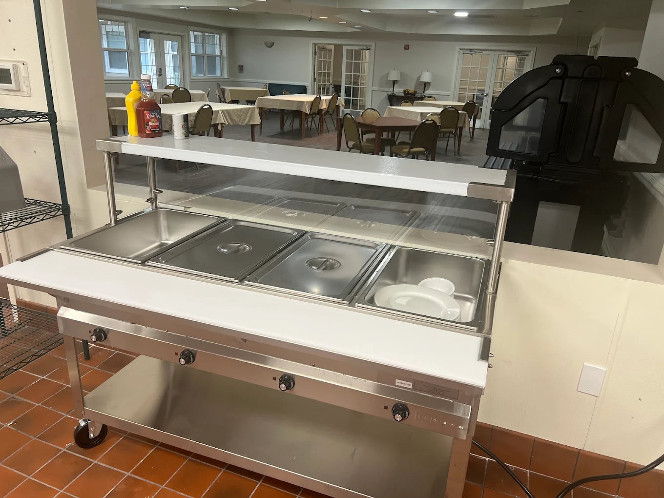 Dining area with tables and food service counter.