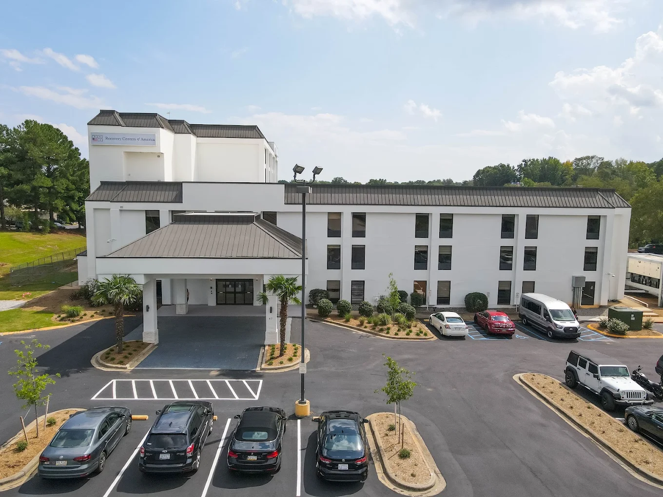 Front entrance of the facility with driveway and parking area