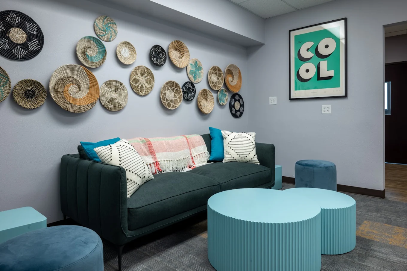 Waiting area with sofa, tables, and decorative wall art