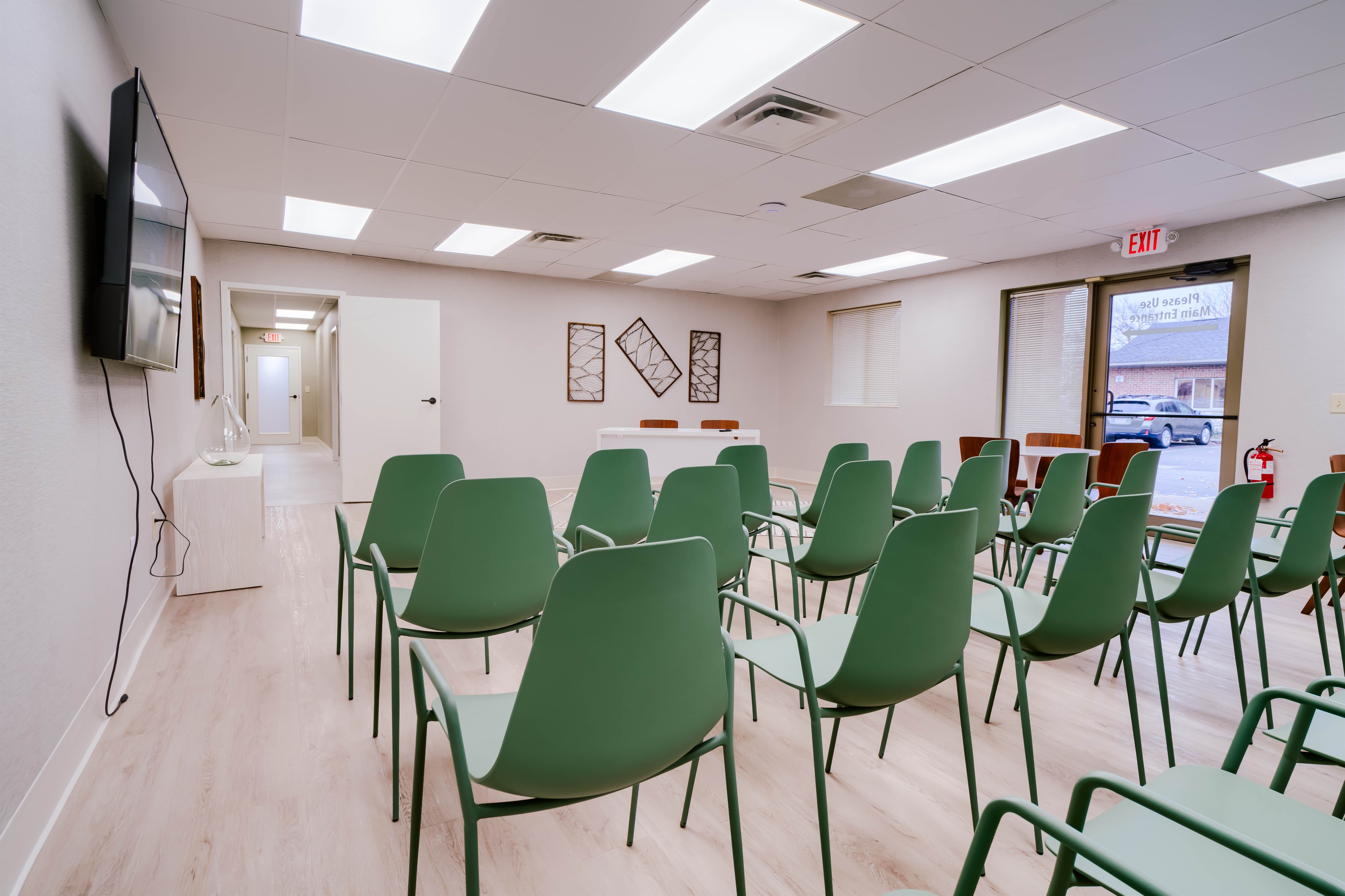 Group therapy room with chairs facing TV