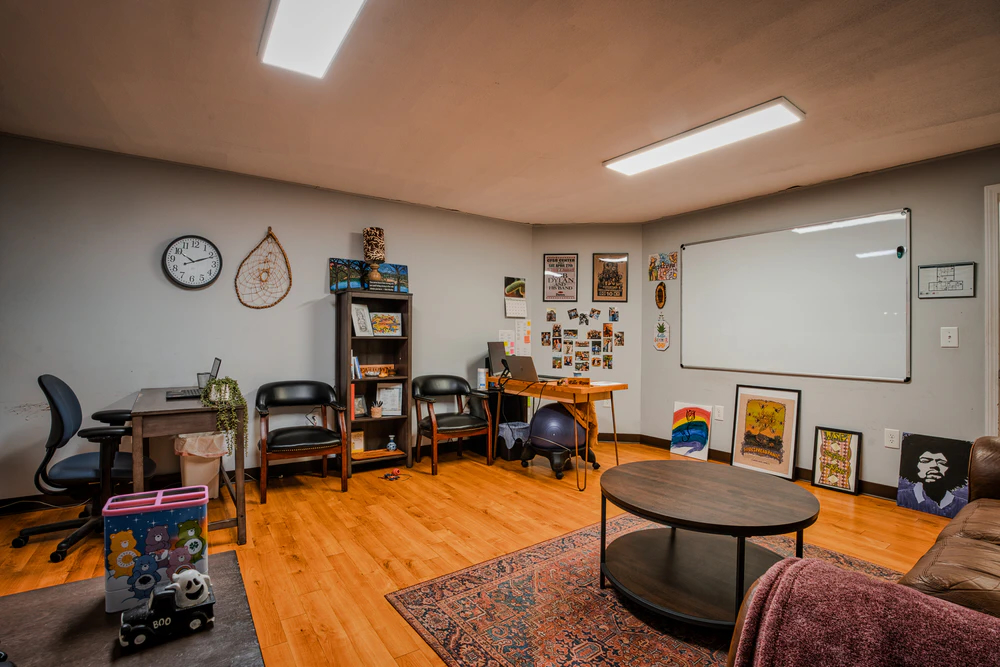 Meeting room with chairs, bookshelves, and a whiteboard