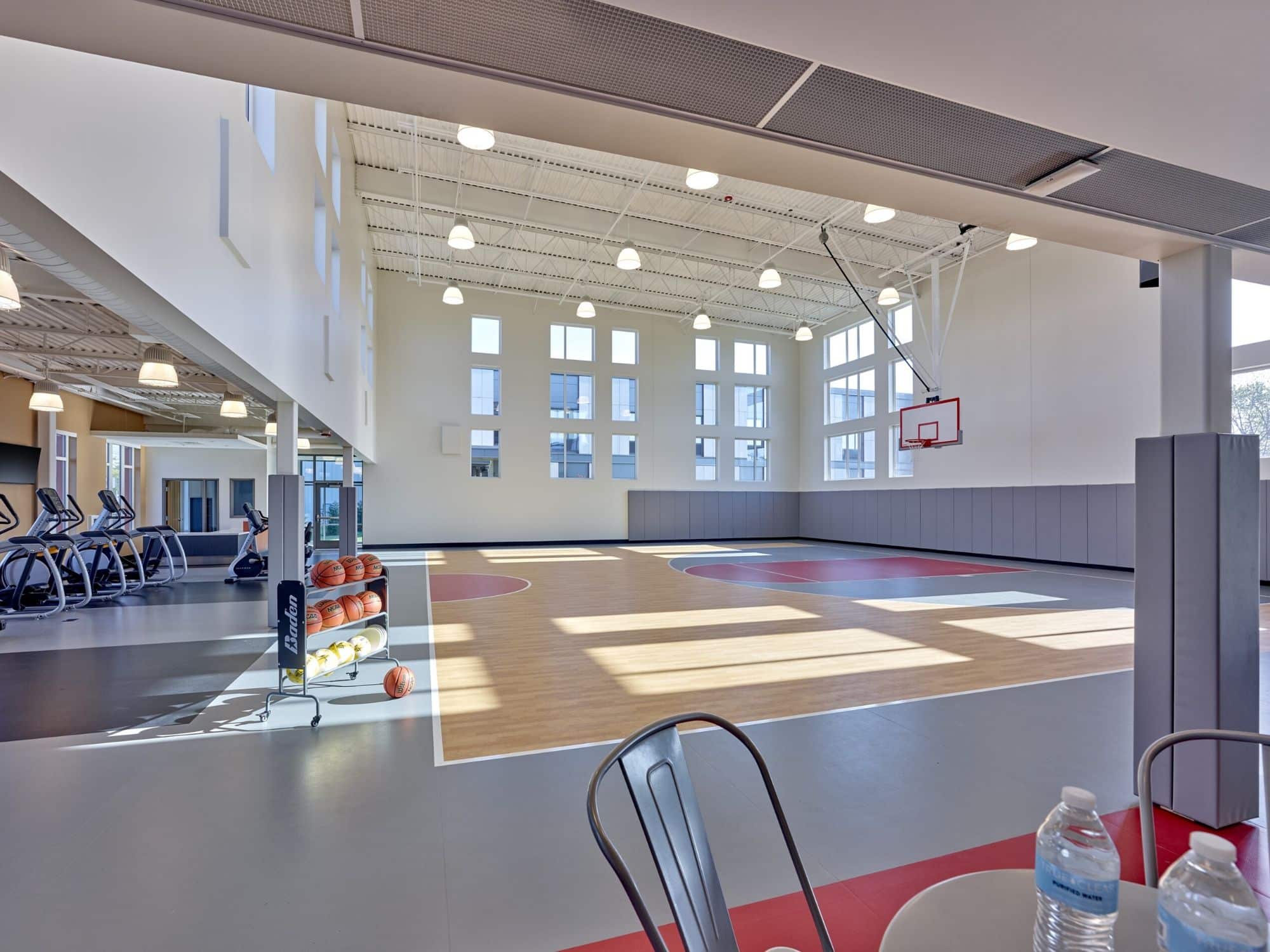 Indoor basketball court with exercise machines on the side