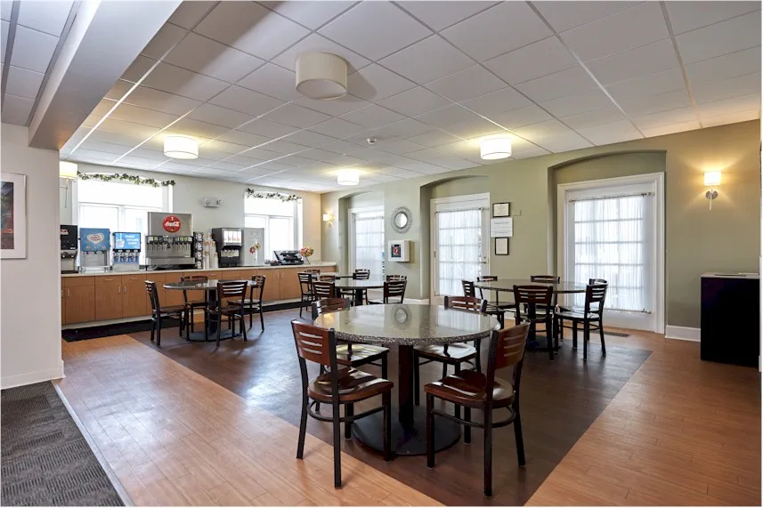 Café-style refreshment area with tables and beverage station.