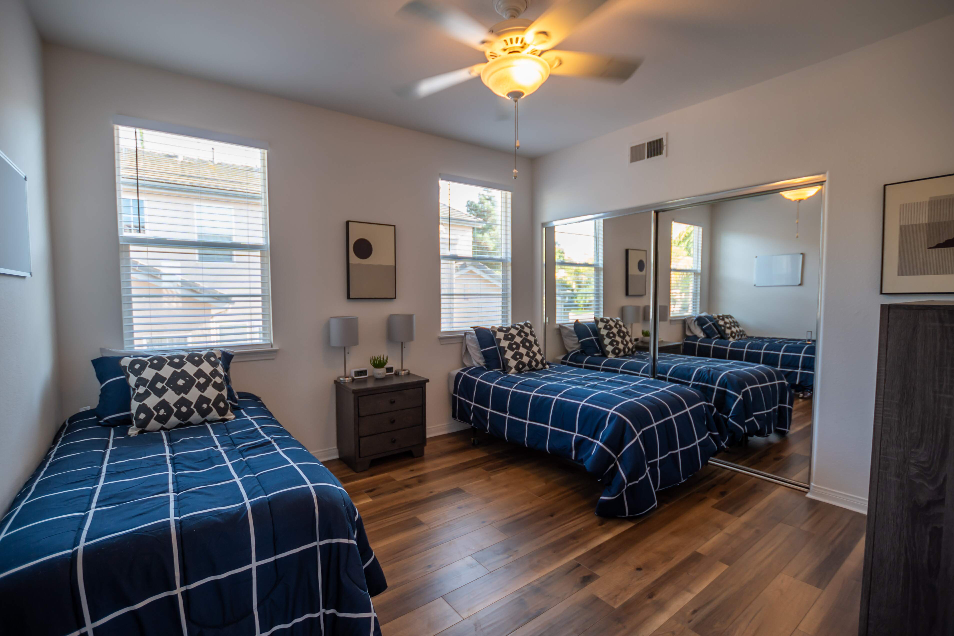 Room with two single beds and mirrored closet