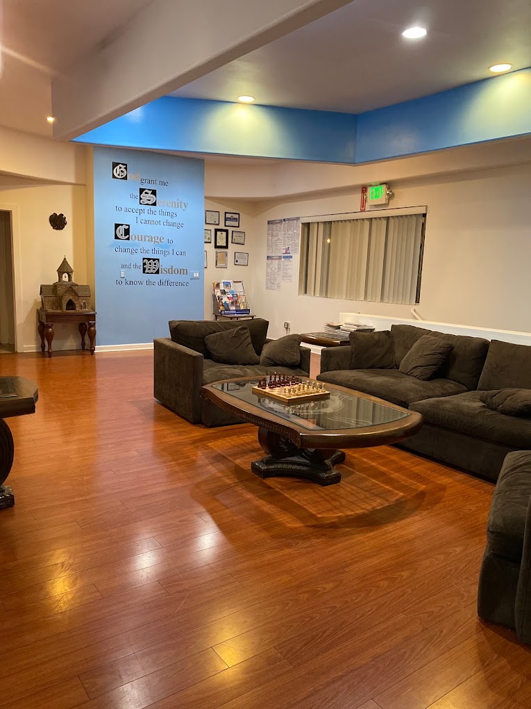 Cozy lounge with brown sofas, coffee table, and chess set