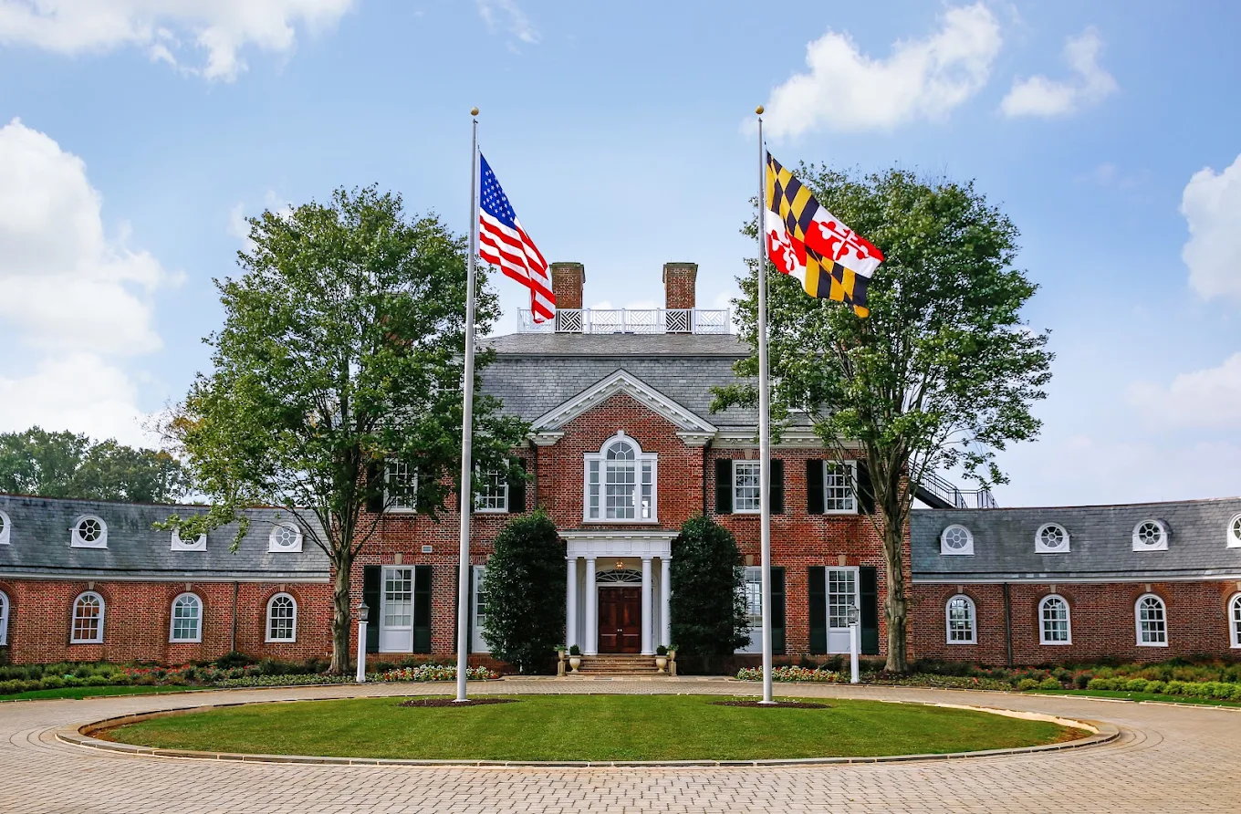 Brick treatment facility entrance with flags and circular drive