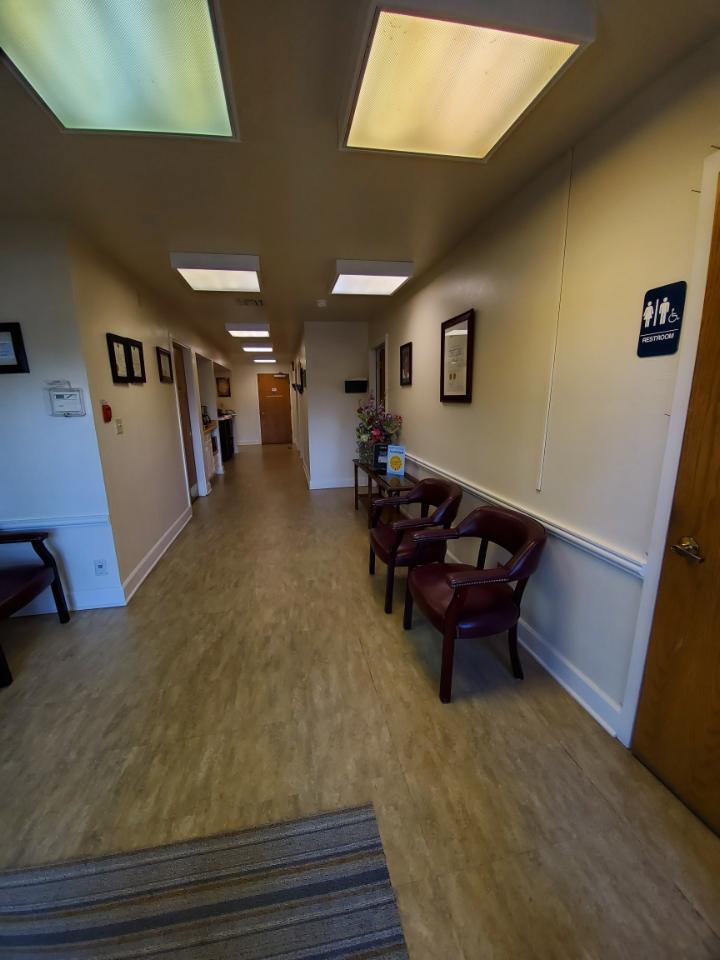 Bright hallway with chairs and framed certificates on wall