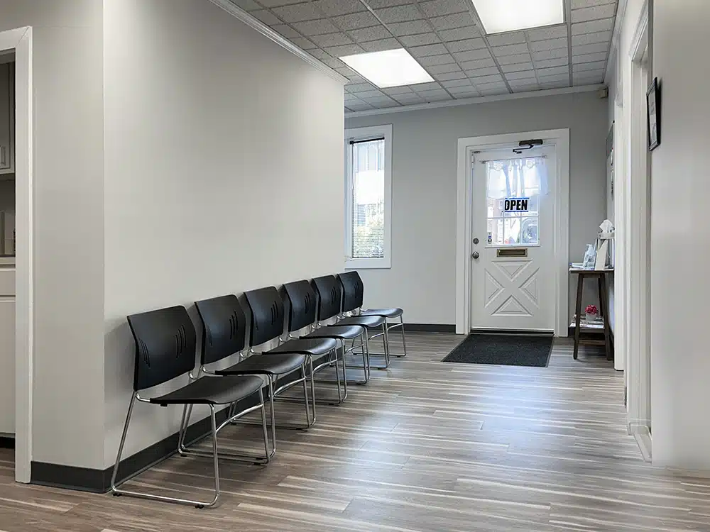 Waiting area with row of chairs near entrance