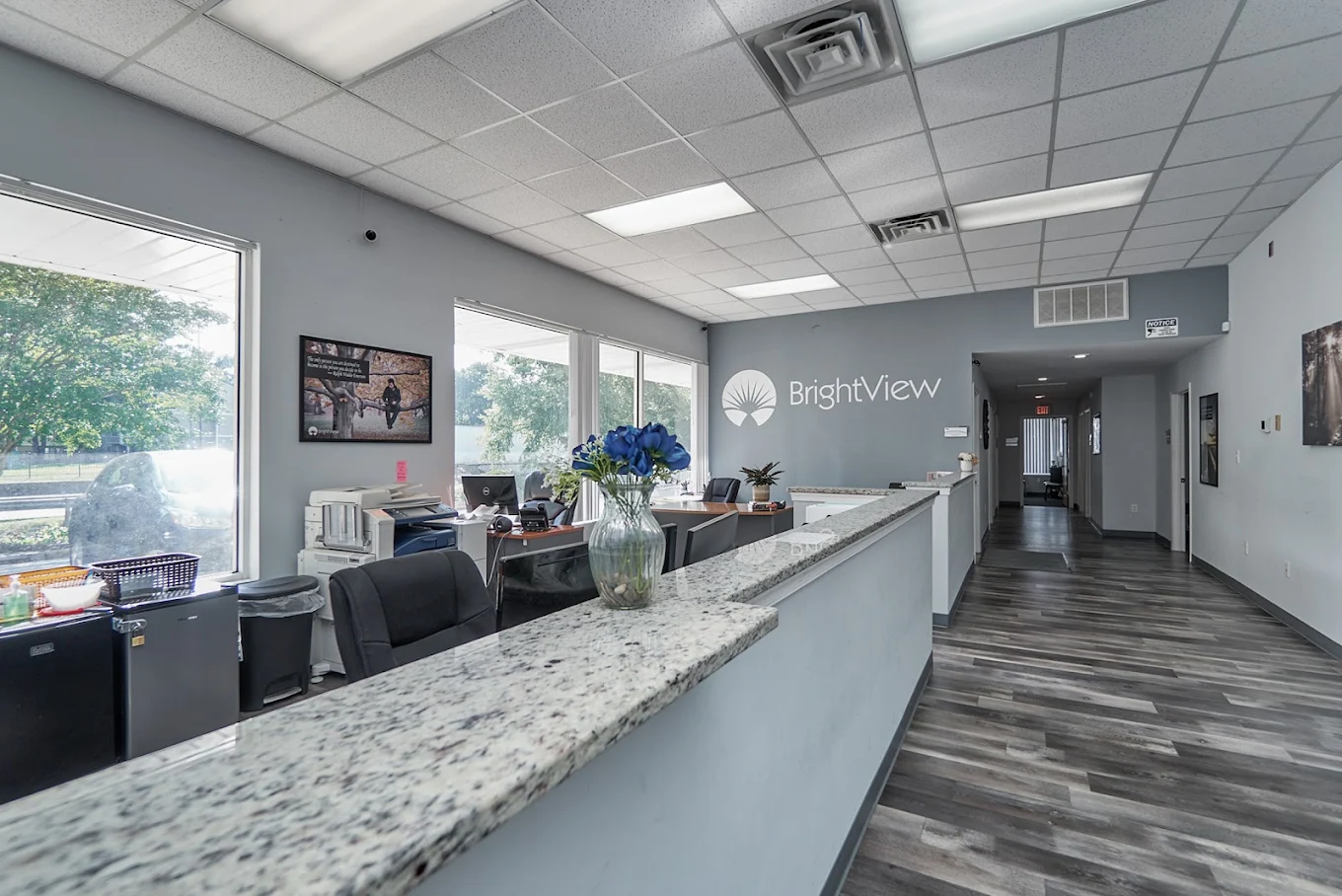 Reception desk with granite counter and BrightView wall logo