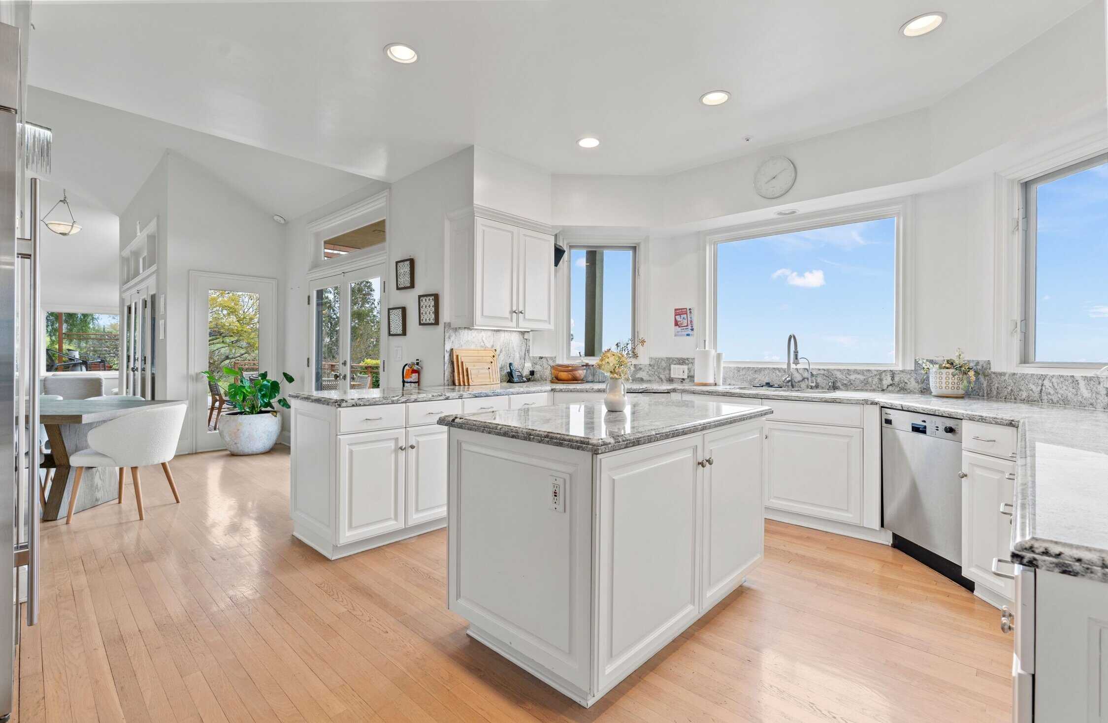 Modern white kitchen with island and ocean views
