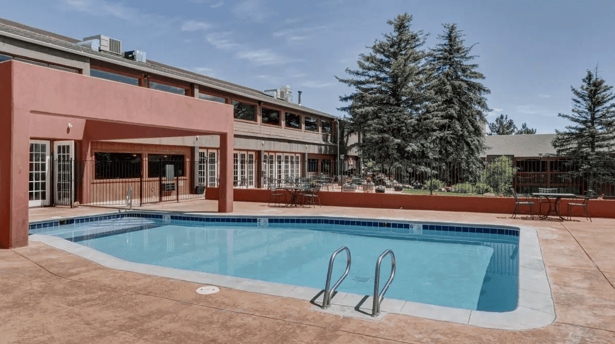 Pool area with patio and seating.