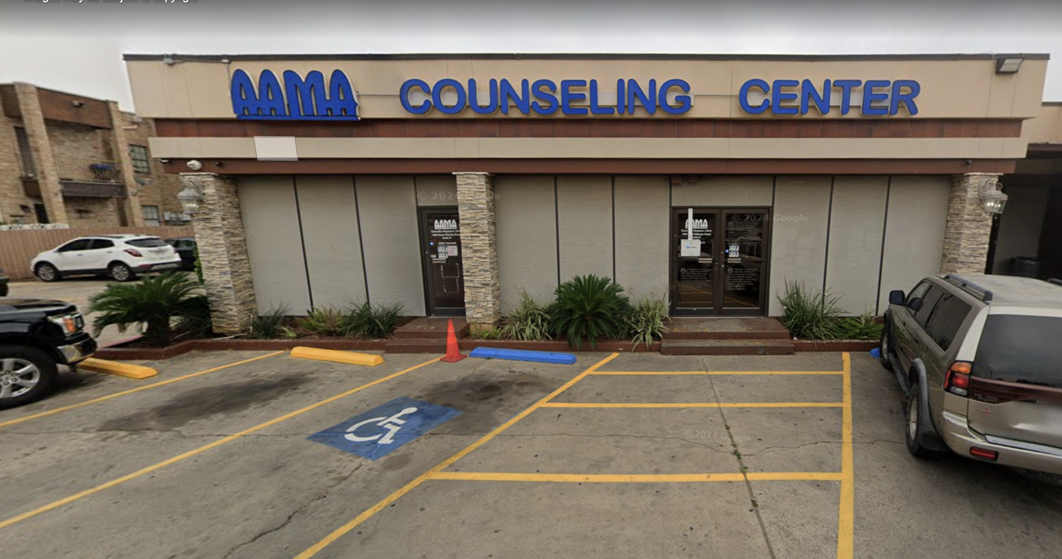 Exterior view of AAMA Counseling Center with parking spaces