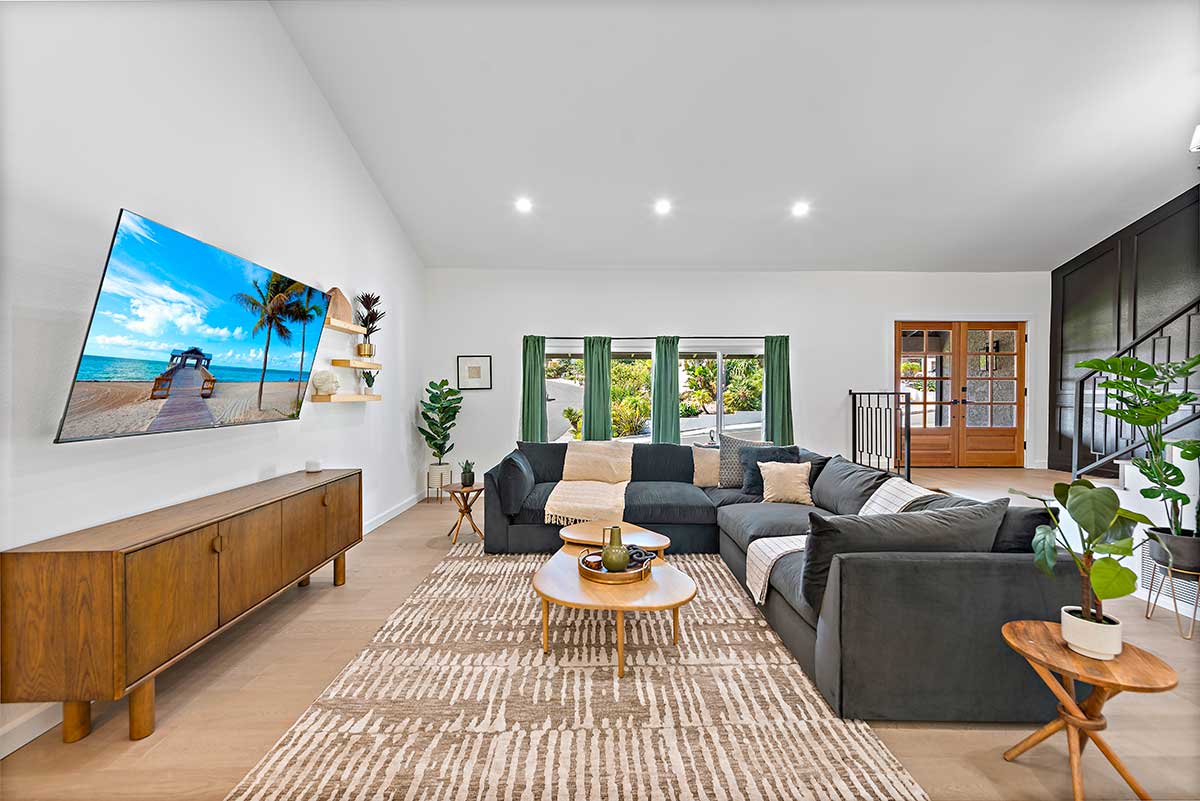 Bright living area with sectional sofa and wall-mounted TV