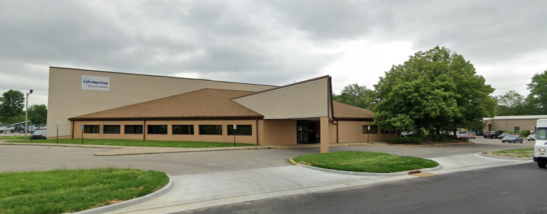 Rehab facility exterior with brown roof and parking lot