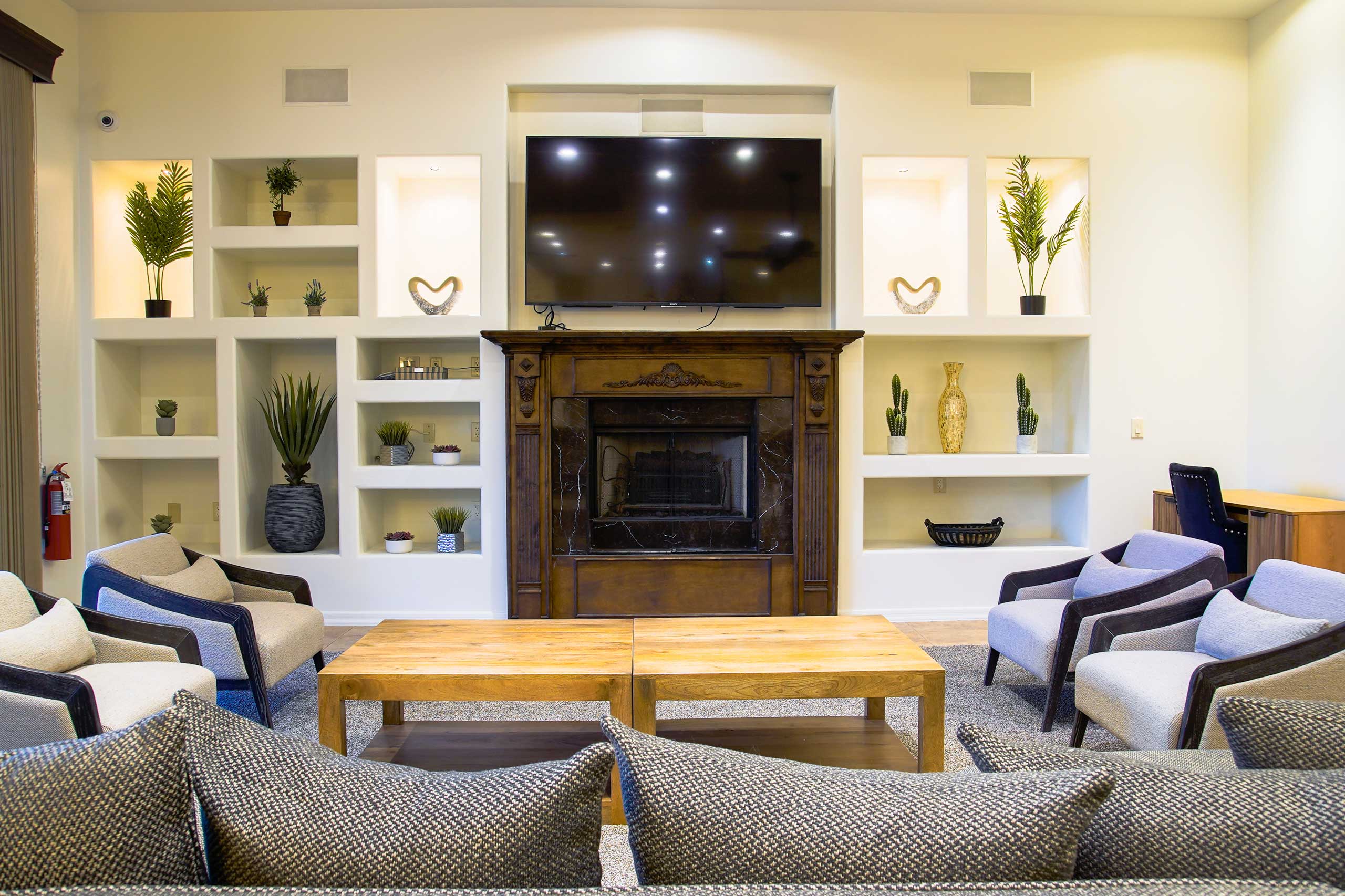 Main living room with seating, fireplace, and TV