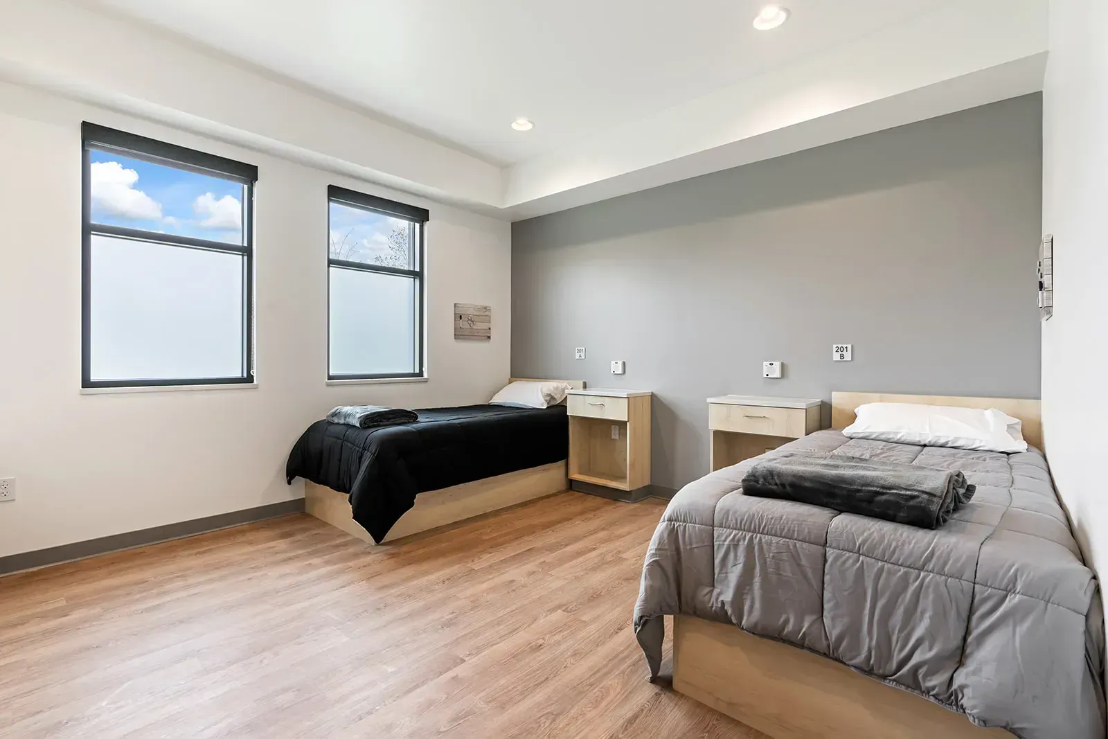 Shared bedroom with two twin beds and large windows
