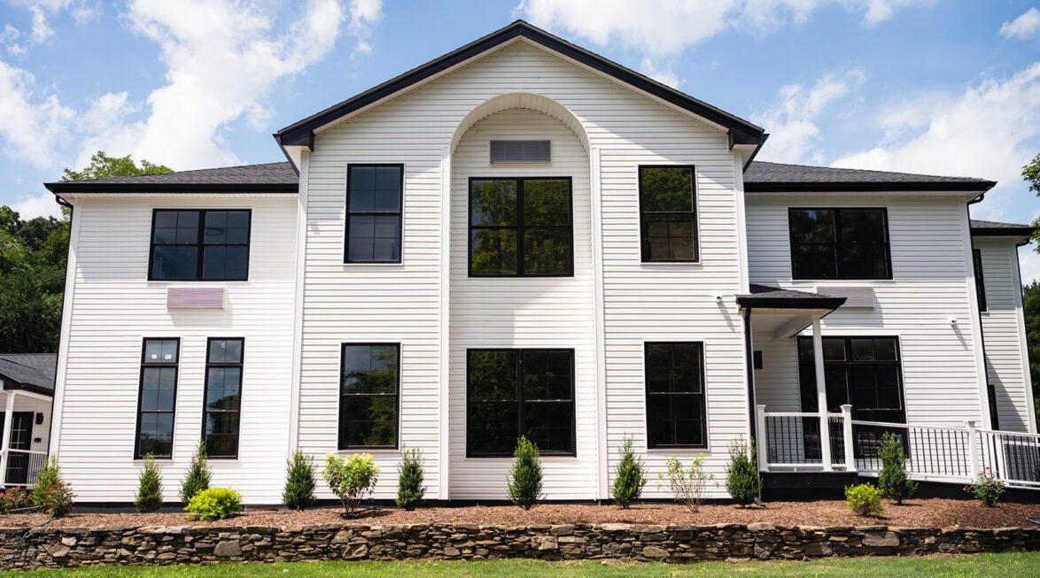 Modern residential treatment building with landscaped entrance and accessible ramp