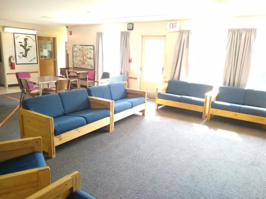 Common area with blue couches and wood furniture