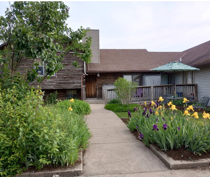 Building entrance with flower garden and walkway