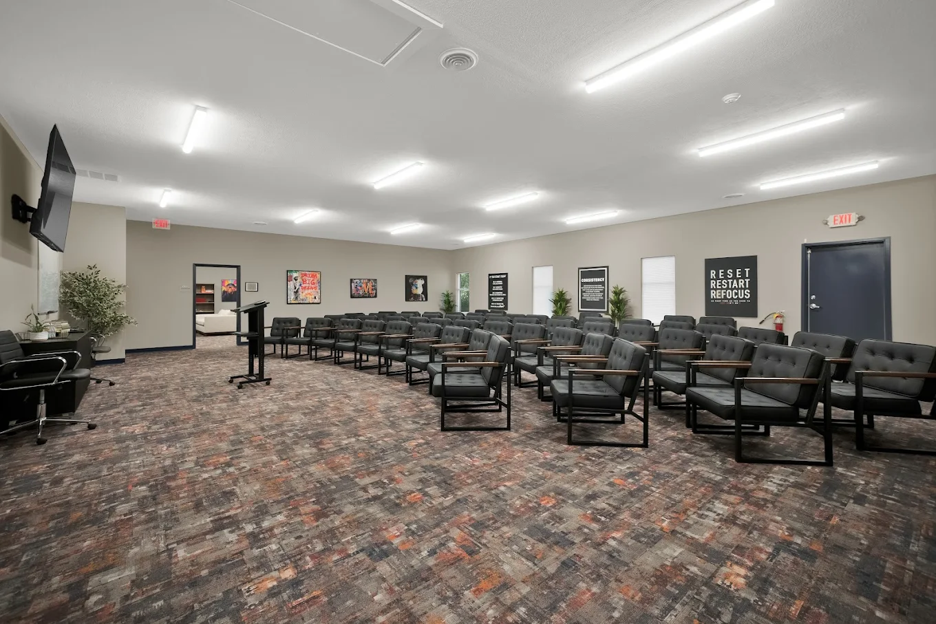 Large group therapy auditorium with rows of chairs