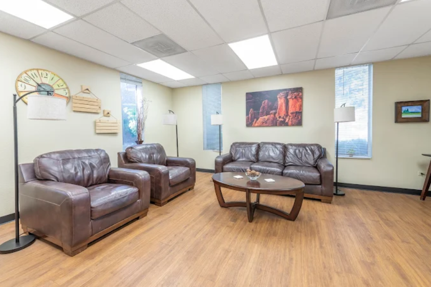 Group room with leather chairs, couch, and coffee table