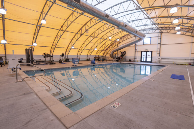 Heated indoor pool with exercise equipment nearby