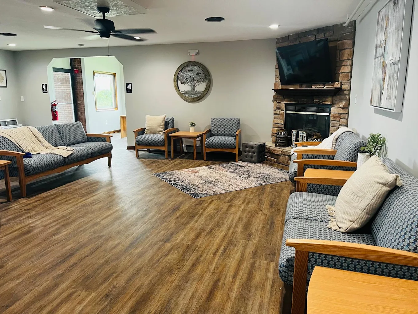 Spacious living room with sofas, chairs, and a fireplace
