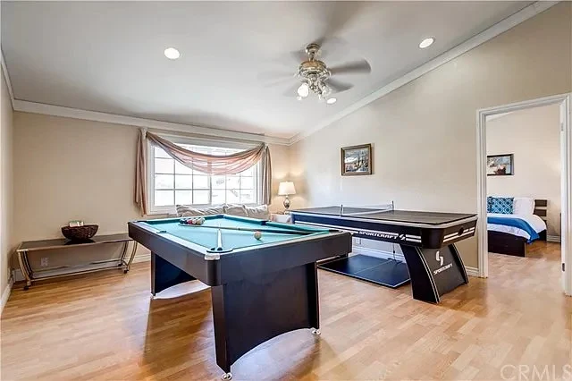 Game room with pool table and ping pong in well-lit space