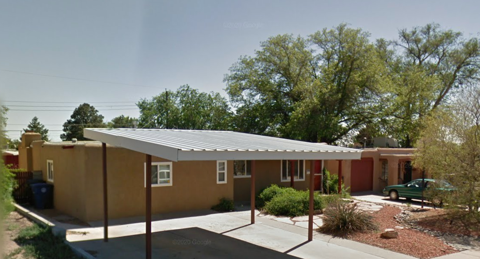 A front view of the Turning Point Detox building, featuring a southwestern design with a stone pathway and a shaded entrance.