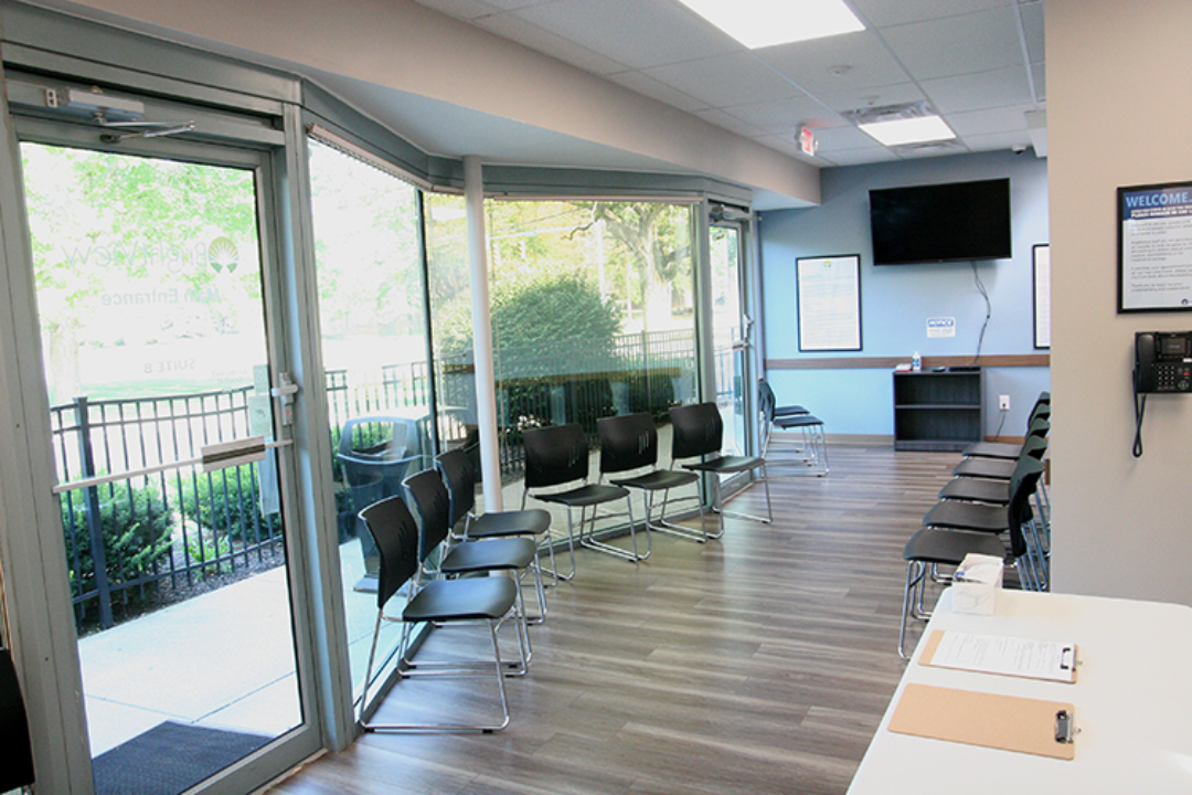 Bright lobby with rows of chairs and large windows