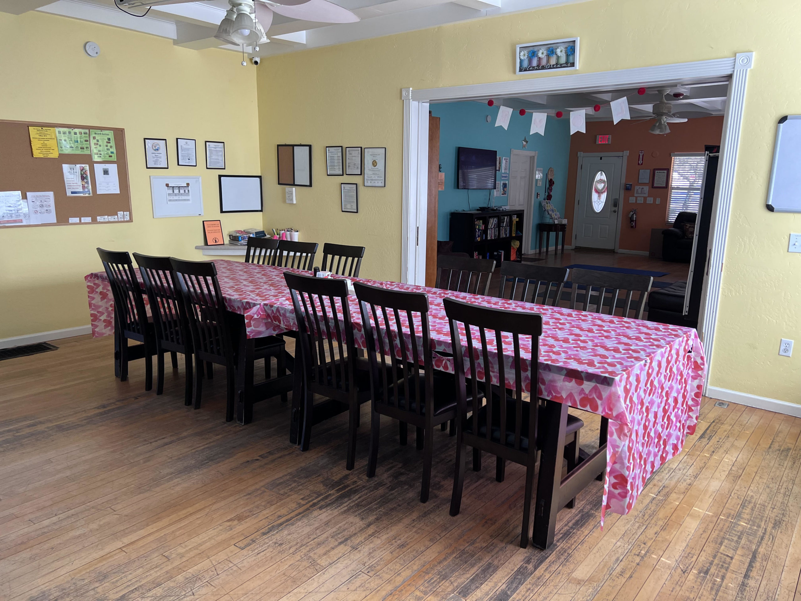 Long dining table with heart-pattern tablecloth