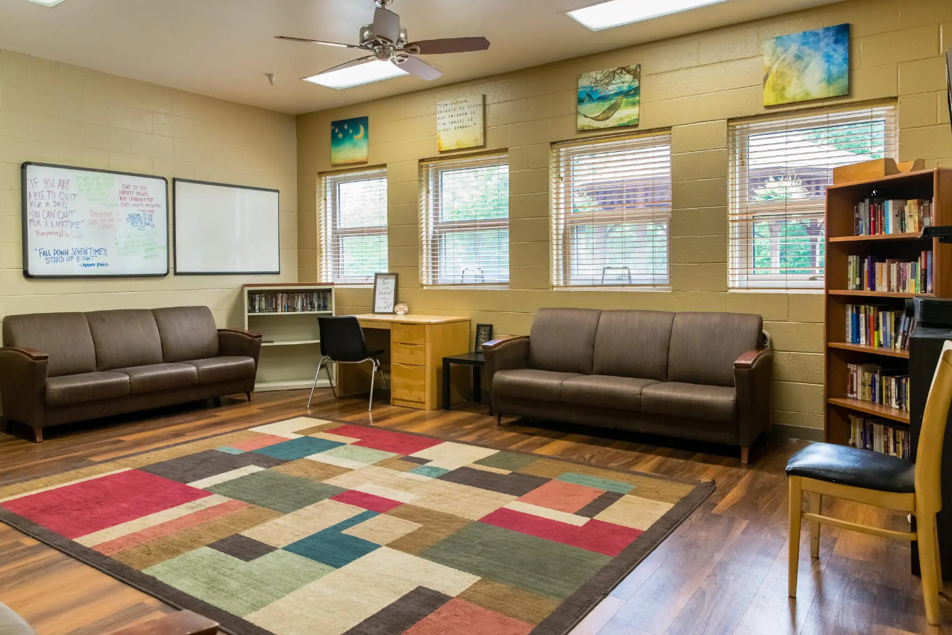Cozy library with couches, bookshelves, and colorful wall art