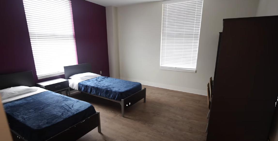 Shared bedroom with two twin beds and large windows