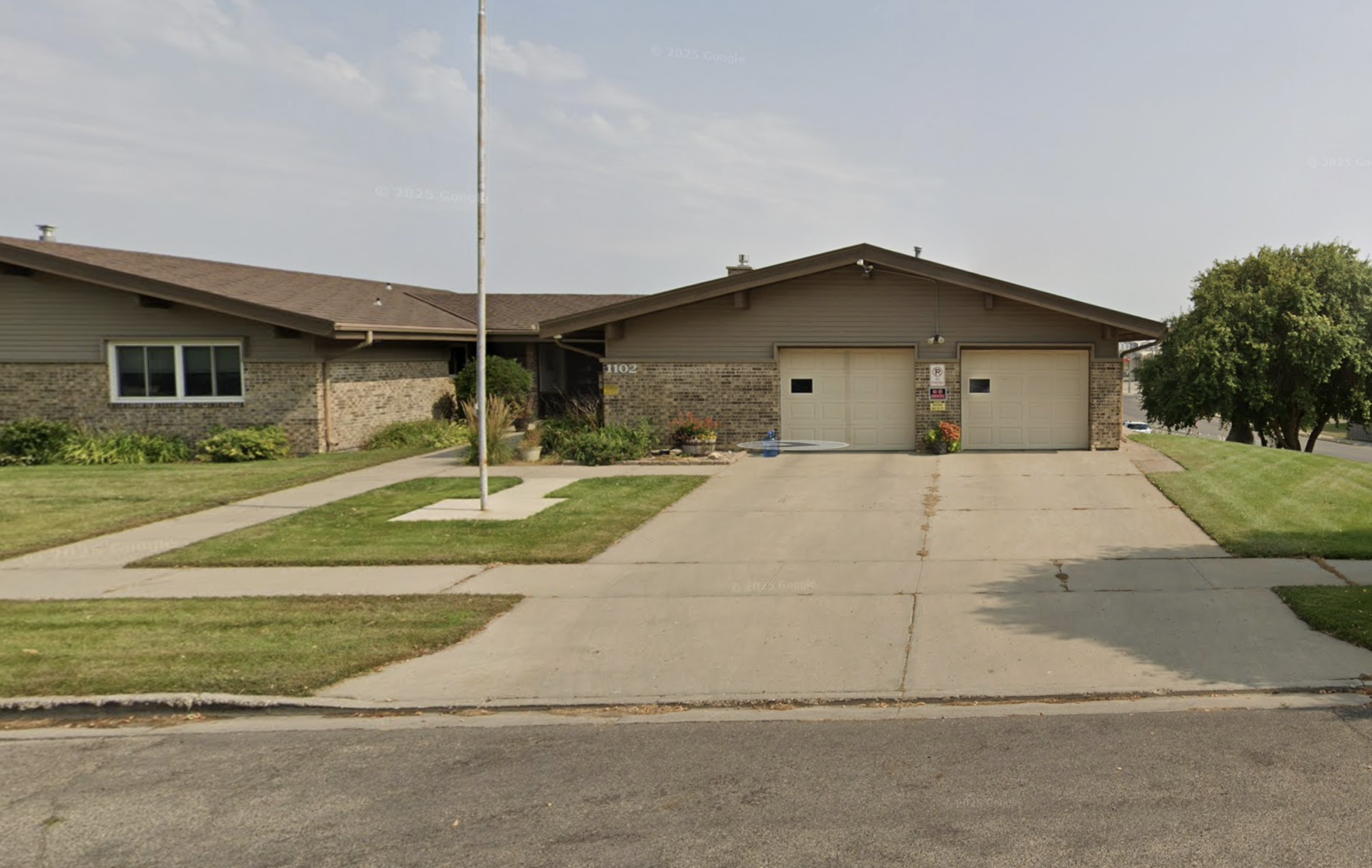 Brick rehab facility with driveway and landscaped lawn