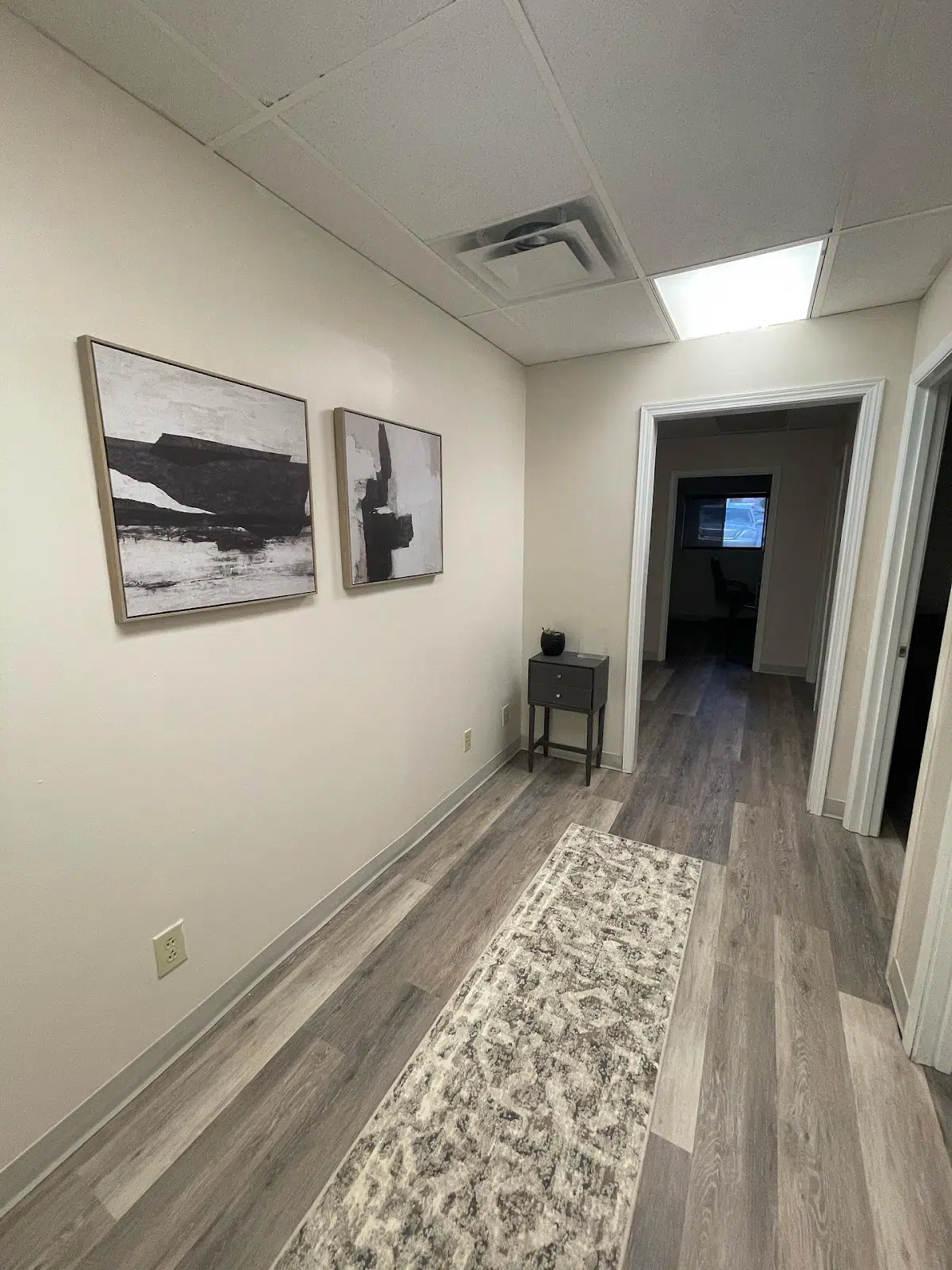 Hallway with rugs, decor, and multiple doorways