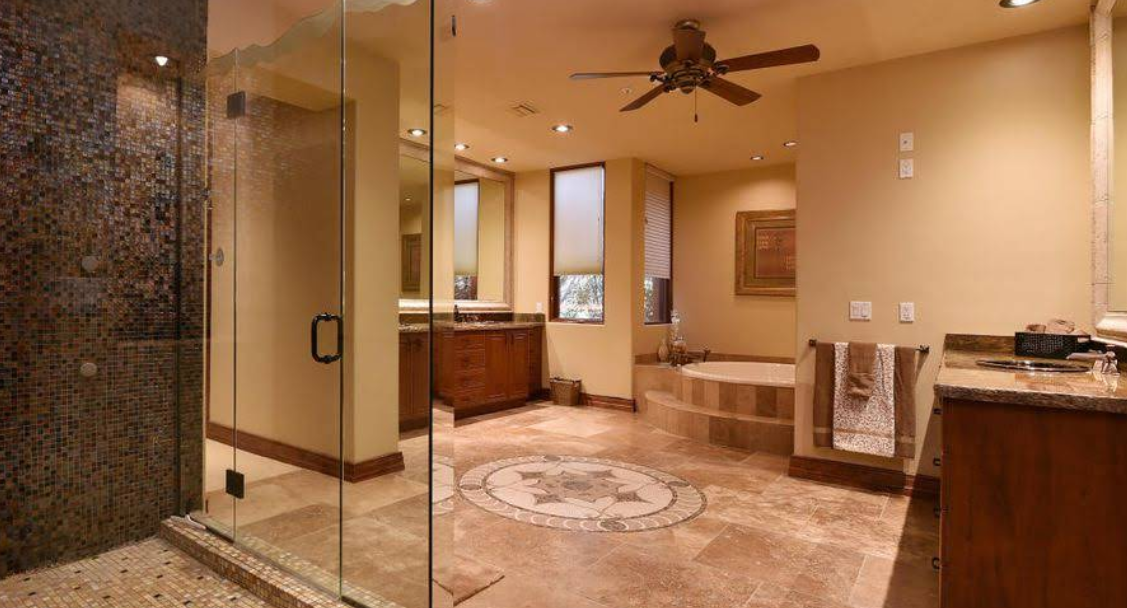 Spacious bathroom with glass shower, tub, and double sinks