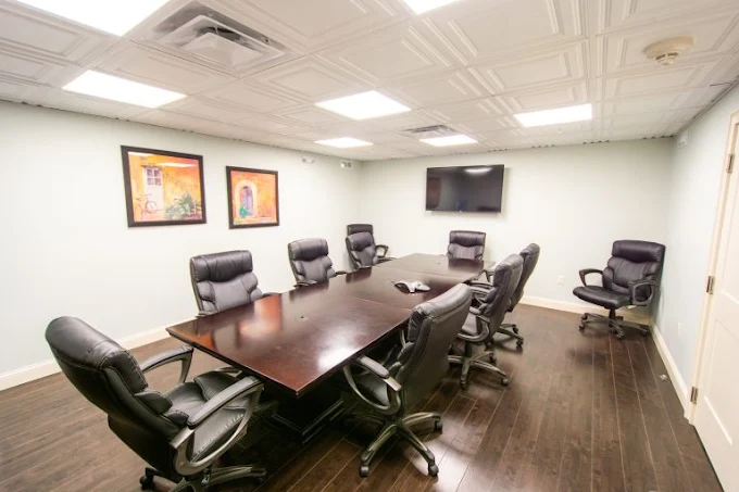Conference room with leather chairs and flat screen
