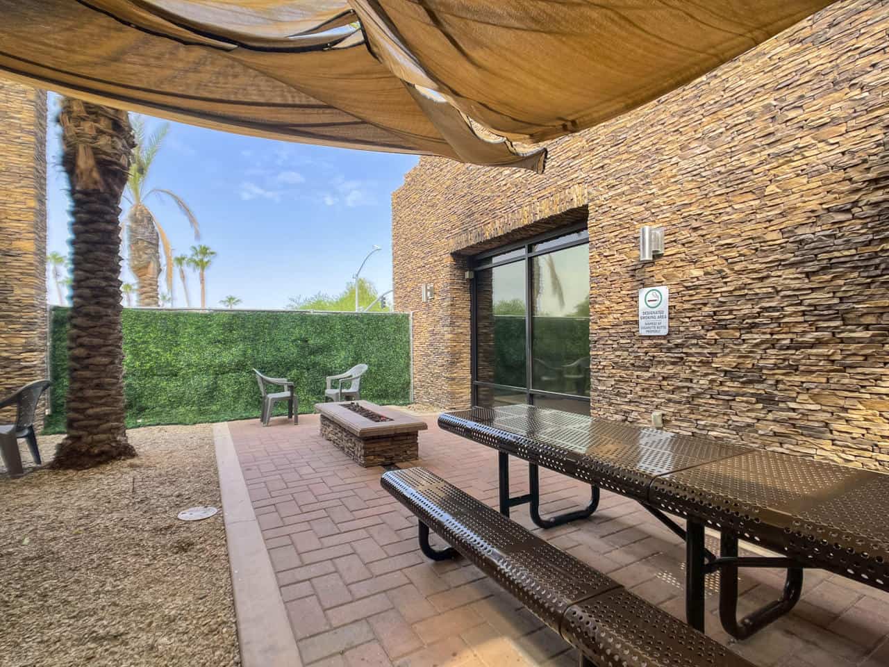 Outdoor patio lounge with seating and shaded area