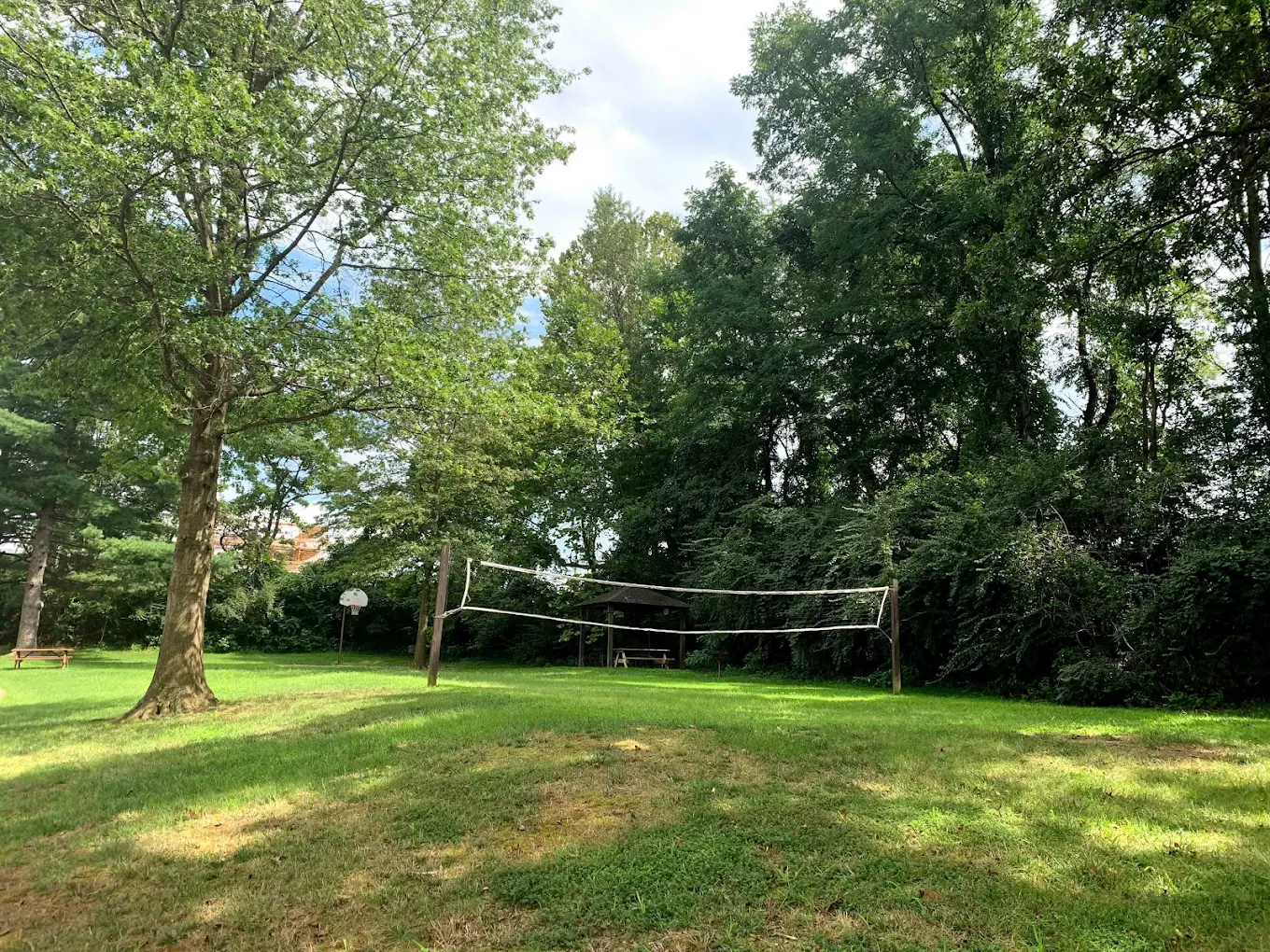 Outdoor courtyard with volleyball net and grass