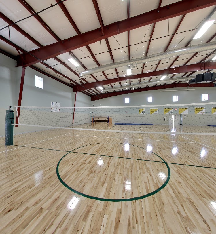 Indoor gymnasium with volleyball court and hardwood floor