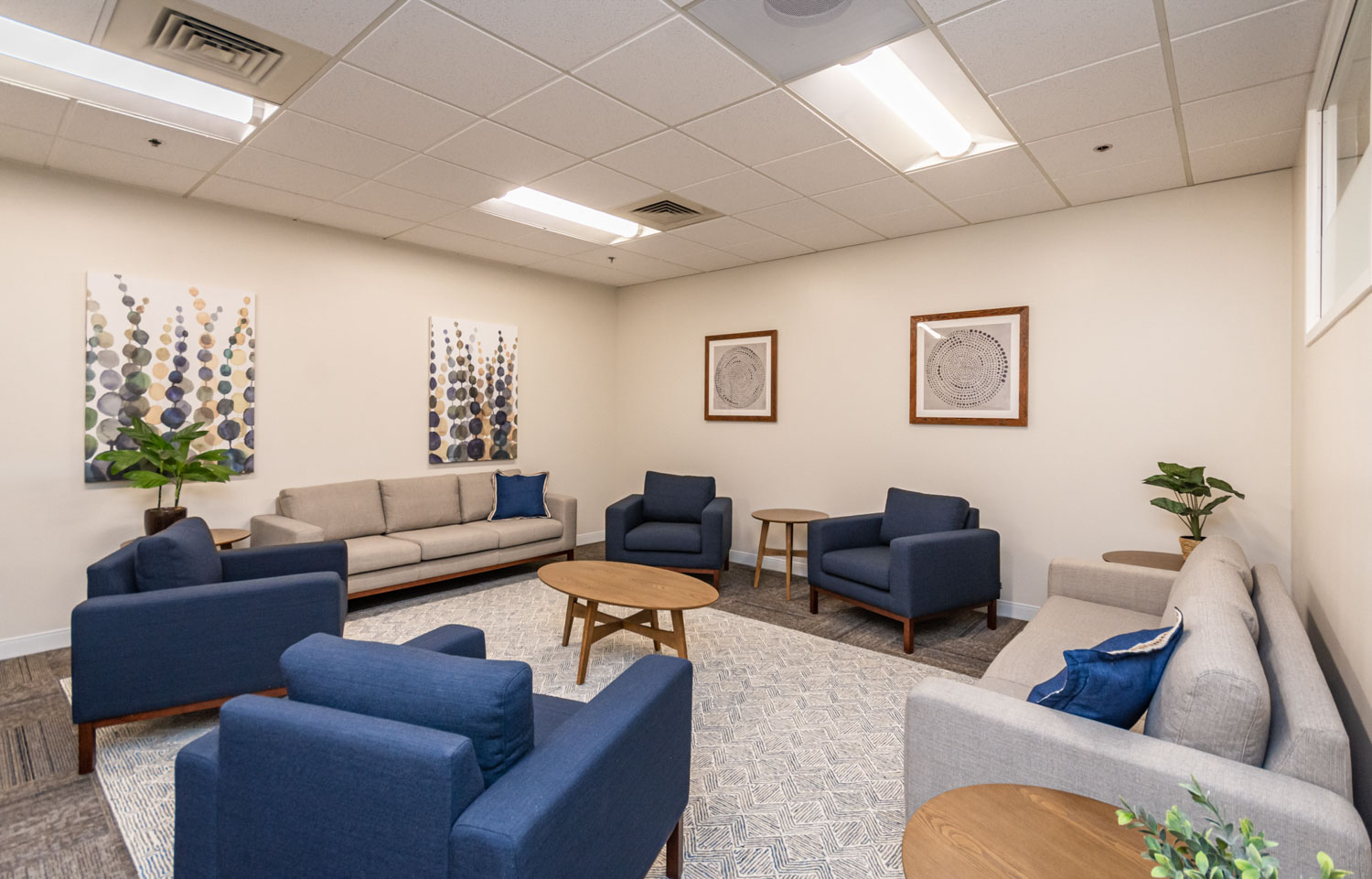 Group therapy room with couches and armchairs in a circle