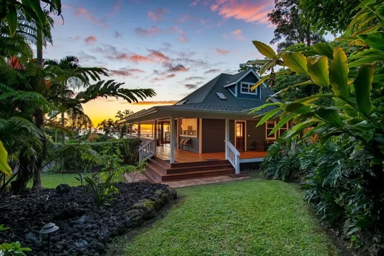 Tropical home exterior lit by sunset sky