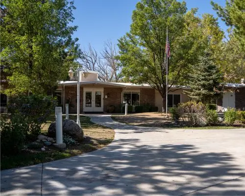 Front entrance of facility with circular driveway and trees