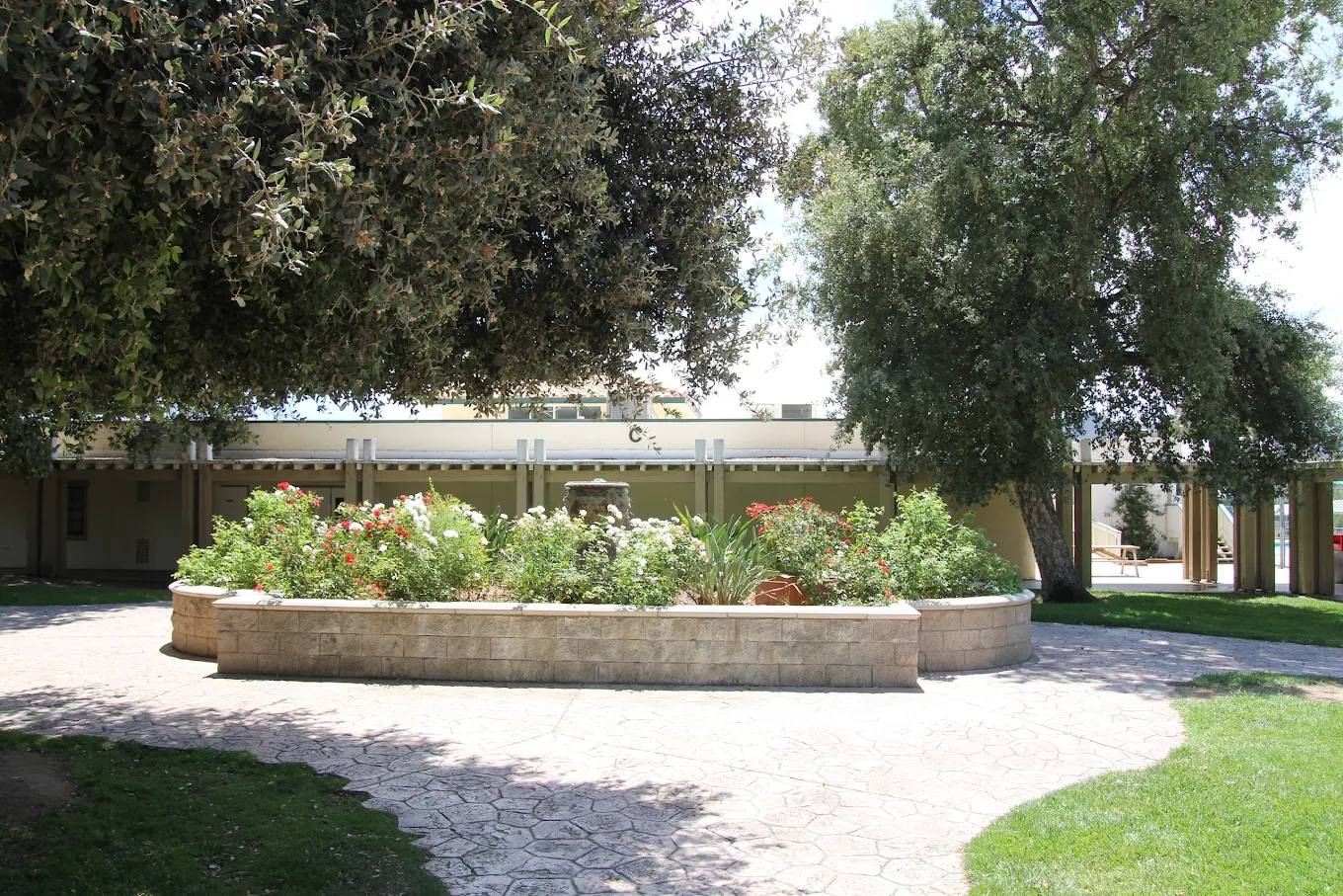 Courtyard garden with fountain, flowers, and walking paths
