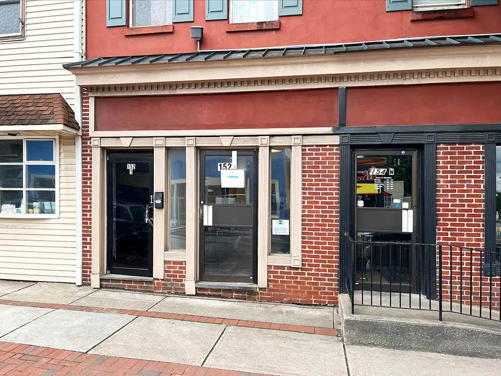 Brick storefront with glass door and clinic signage