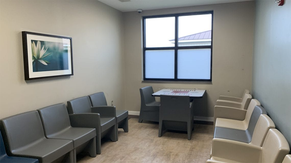 Small consultation room with chairs, table, and window