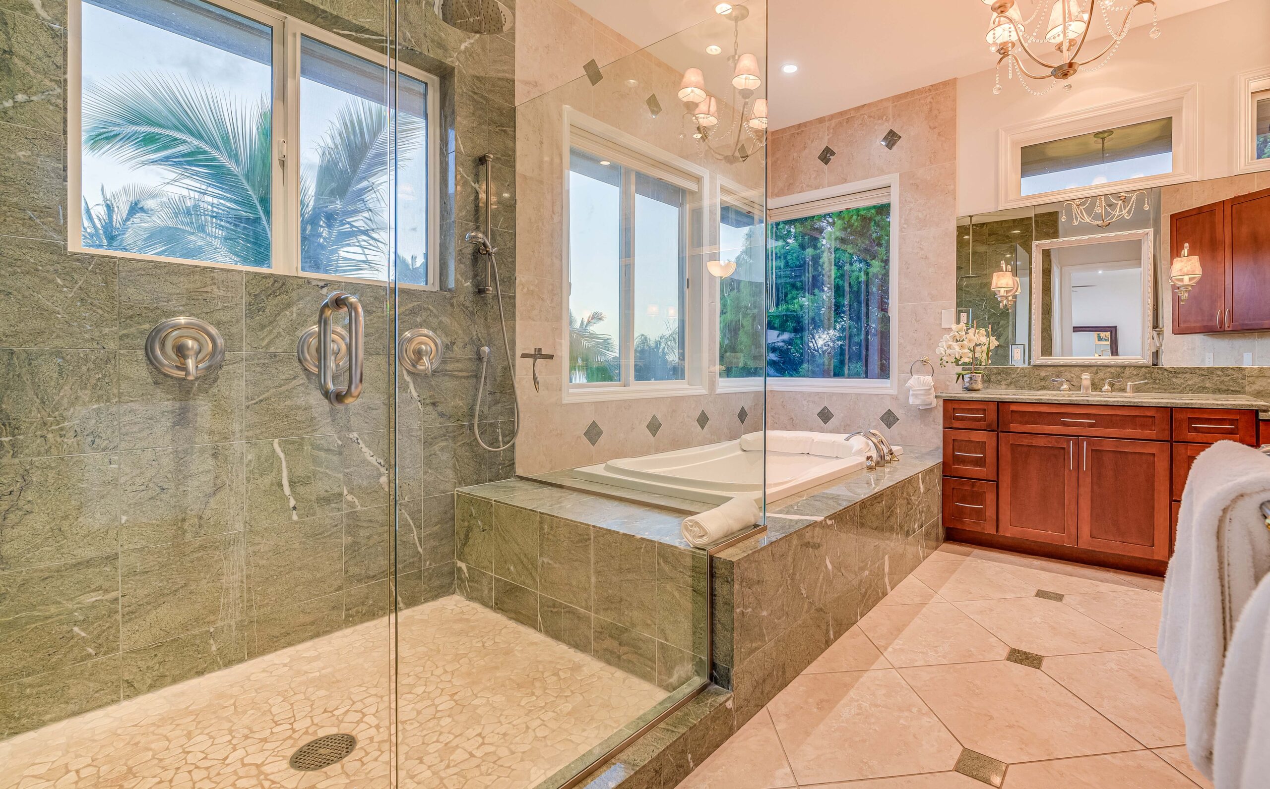 Luxury bathroom featuring a walk-in rainfall shower, soaking tub, and dual vanity
