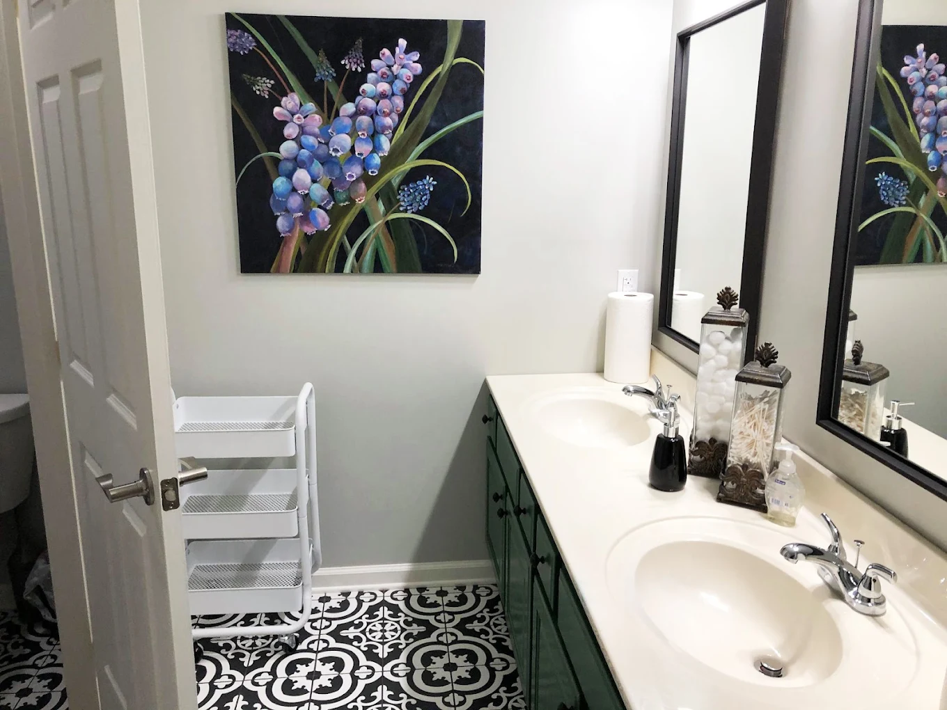 Shared bathroom with double sinks and patterned tile floor