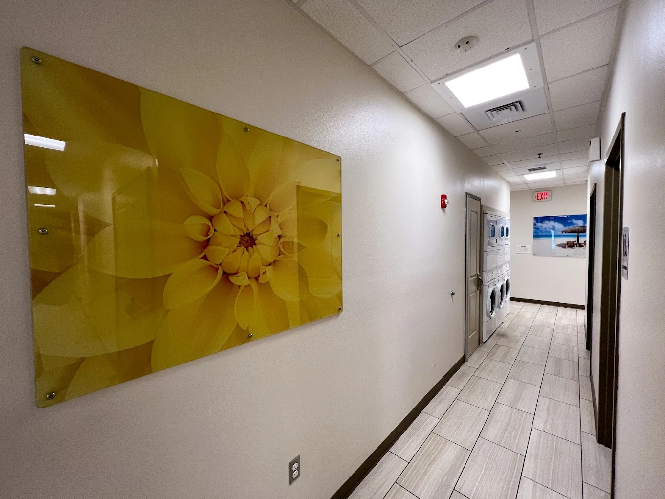 Hallway with stacked washers and dryers